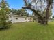 Home's exterior with mature landscaping at 9140 & 9130 Peony St, New Port Richey, FL 34654