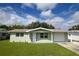 Charming light green house with a one-car garage and well-maintained lawn at 4607 Nimmer Dr, New Port Richey, FL 34652