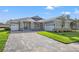 Two-car garage and paver driveway leading to the front door at 19486 Sheltered Hill Dr, Brooksville, FL 34601