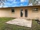 A simple backyard with a small patio and double door entry from the house at 7206 Ashwood Dr, Port Richey, FL 34668
