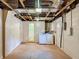 Unfinished basement space with laundry area, utilities, and concrete floor ready for customization at 7206 Ashwood Dr, Port Richey, FL 34668