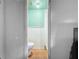 This is a full bath with shower, toilet, and sink. The walls are painted a calming light green at 7206 Ashwood Dr, Port Richey, FL 34668