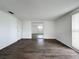 Spacious bedroom with dark wood-look floors, white walls, closet with mirrored doors, and natural light at 7206 Ashwood Dr, Port Richey, FL 34668