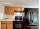 The kitchen features wood cabinets, essential appliances, offering functionality and style at 7206 Ashwood Dr, Port Richey, FL 34668