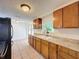 Spacious kitchen with wood cabinets, tile floors, double sink, and ample natural light at 7206 Ashwood Dr, Port Richey, FL 34668