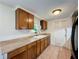 A functional kitchen showcases wood cabinets, tile flooring and plenty of counter space at 7206 Ashwood Dr, Port Richey, FL 34668