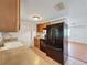 The kitchen features wood cabinets, tile floors, and essential appliances, offering functionality at 7206 Ashwood Dr, Port Richey, FL 34668