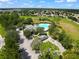 Aerial view of community pool, clubhouse, and surrounding homes at 14367 Saltby Pl, Spring Hill, FL 34609