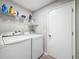 Laundry room with washer, dryer, and shelving at 14367 Saltby Pl, Spring Hill, FL 34609