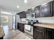 Modern kitchen with stainless steel appliances and granite countertops at 14367 Saltby Pl, Spring Hill, FL 34609