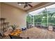 Screened porch with tile floor, table, and cat furniture at 1641 Bayfield Ct, Trinity, FL 34655