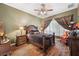 Well-lit bedroom with wood flooring, a ceiling fan, and a large window at 1641 Bayfield Ct, Trinity, FL 34655