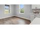 Kitchen area with white cabinets and hardwood floors at 5406 Boxtree Ct, Dade City, FL 33523