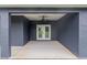 Covered patio with double doors and ceiling fan at 5406 Boxtree Ct, Dade City, FL 33523