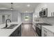 Modern kitchen with white cabinets, stainless steel appliances, and an island at 5406 Boxtree Ct, Dade City, FL 33523
