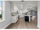 Modern kitchen with white cabinets, island, and dark-colored flooring at 5406 Boxtree Ct, Dade City, FL 33523