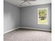 Bedroom with grey walls, carpet, and ceiling fan at 5406 Boxtree Ct, Dade City, FL 33523