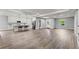 Open concept living room and kitchen with wide-plank flooring at 5406 Boxtree Ct, Dade City, FL 33523
