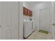 Laundry room with washer, dryer, and extra storage at 10223 Sorenstam Dr, Trinity, FL 34655