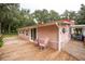 Pink house exterior with rocking chairs on deck at 24514 Audubon Dr, Brooksville, FL 34601