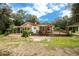 Ranch home with large deck, screened porch, and landscaped yard at 24514 Audubon Dr, Brooksville, FL 34601
