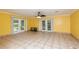 Large living room with tile floors and French doors at 24514 Audubon Dr, Brooksville, FL 34601
