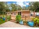 Ranch home with wooden deck, landscaping, and spacious backyard at 24514 Audubon Dr, Brooksville, FL 34601