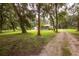 Ranch home with screened porch surrounded by mature trees at 24514 Audubon Dr, Brooksville, FL 34601