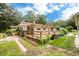 Ranch home with wooden deck, landscaping, and spacious backyard at 24514 Audubon Dr, Brooksville, FL 34601