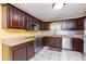 Spacious kitchen with granite countertops and dark wood cabinets at 24514 Audubon Dr, Brooksville, FL 34601