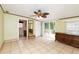 Main bedroom with tile floor, ceiling fan, and access to bathroom and deck at 24514 Audubon Dr, Brooksville, FL 34601