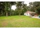 Detached garage with covered carport and a grassy yard at 24514 Audubon Dr, Brooksville, FL 34601