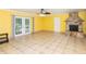 Living room with stone fireplace and French doors at 24514 Audubon Dr, Brooksville, FL 34601