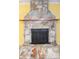 Stone fireplace with a black metal surround at 24514 Audubon Dr, Brooksville, FL 34601