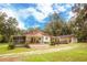 Charming ranch home with a large screened porch, deck, and fenced yard at 24514 Audubon Dr, Brooksville, FL 34601