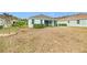 House and backyard view, showing lawn and landscaping at 11143 Merganser Way, New Port Richey, FL 34654