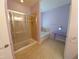 Bathroom with glass enclosed shower and adjacent tub at 11143 Merganser Way, New Port Richey, FL 34654