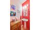 Stylish bathroom with pedestal sink and red walls at 11143 Merganser Way, New Port Richey, FL 34654