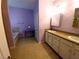 Bathroom featuring double sinks, a bathtub, and tile flooring at 11143 Merganser Way, New Port Richey, FL 34654