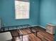 Cozy bedroom with hardwood floors, a metal bed frame, and a white nightstand at 11143 Merganser Way, New Port Richey, FL 34654