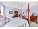 Primary bedroom featuring a four poster bed and comfortable interior design at 11143 Merganser Way, New Port Richey, FL 34654