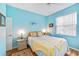 Light blue bedroom with a queen bed and ample natural light at 11143 Merganser Way, New Port Richey, FL 34654