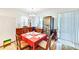 Cozy dining room featuring wood furniture, tile floors, wine cooler, and sliding door to the outside at 11143 Merganser Way, New Port Richey, FL 34654