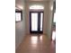 Inviting entryway featuring tile flooring, an ornate front door and sidelights, and transom window at 11143 Merganser Way, New Port Richey, FL 34654