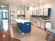 Modern kitchen with white cabinets, mosaic backsplash, and a large island with a white countertop at 11143 Merganser Way, New Port Richey, FL 34654