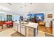 Open concept kitchen features an island and stainless appliances and opens to dining and living areas at 11143 Merganser Way, New Port Richey, FL 34654