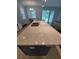 Kitchen island with a marble countertop, stainless steel sink, and sliding doors to the outside at 11143 Merganser Way, New Port Richey, FL 34654