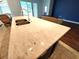 Close-up of a kitchen island with a white countertop, double sink, and stylish fixtures at 11143 Merganser Way, New Port Richey, FL 34654