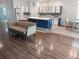 Spacious kitchen features an island, white cabinets with blue trim, tile backsplash and stainless appliances at 11143 Merganser Way, New Port Richey, FL 34654