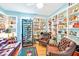 Living room showing wine fridge, leather furniture, and shelving at 11143 Merganser Way, New Port Richey, FL 34654